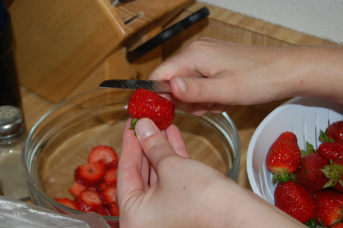cutting lots of strawberries