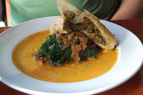 lentil roulade in phyllo over carrot cream sauce and swiss chard